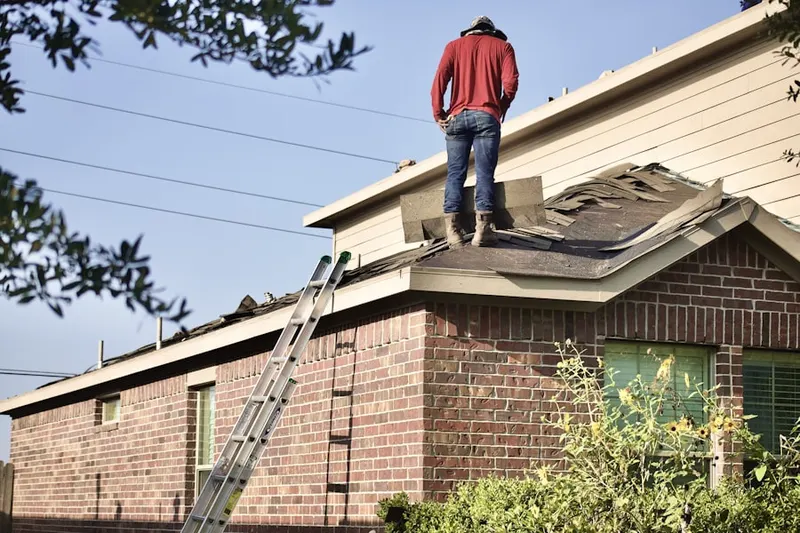 Professional roofer working on a residential roof in Parkville